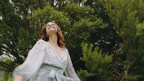 Pretty woman enjoying and dancing at park