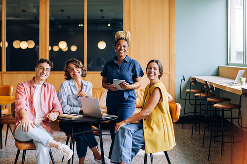 Happy coworkers enjoy a productive meeting in a contemporary office setting