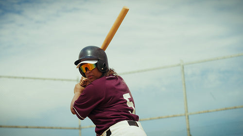 Female baseball player delivers a powerful hit at the plate