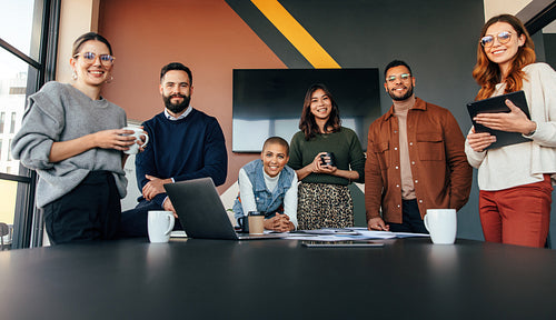 Successful bsuinesspeople smiling at the camera in a boardroom