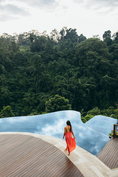 Young woman walking by the pool