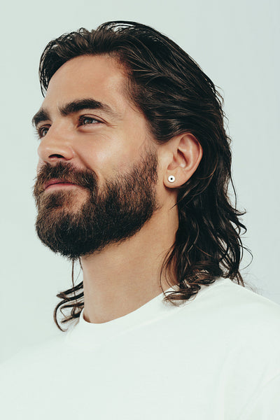 Confident man in a studio, with perfect hair and perfect skin
