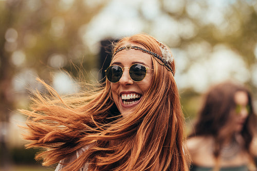 Smiling woman in retro look at music festival
