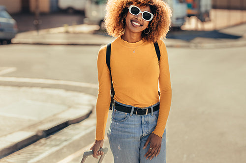 Smiling tourist woman walking on street