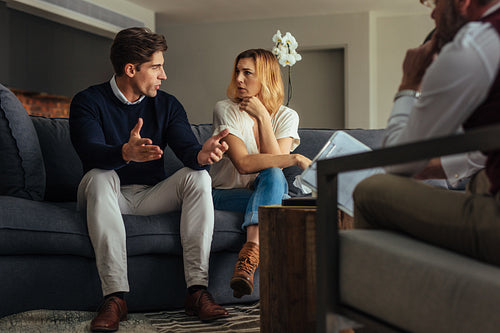 Couple arguing during therapy session with psychologist