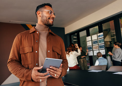 Businessman smiling cheerfully in a boardroom