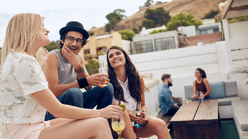 Friends hanging out on rooftop having a party