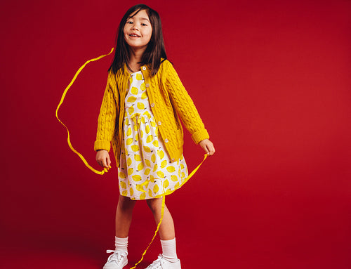 Kid having fun playing with decorative ribbons