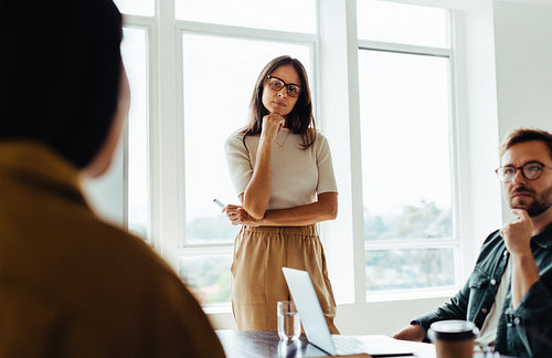 Business woman listening to a discussion in a team meeting