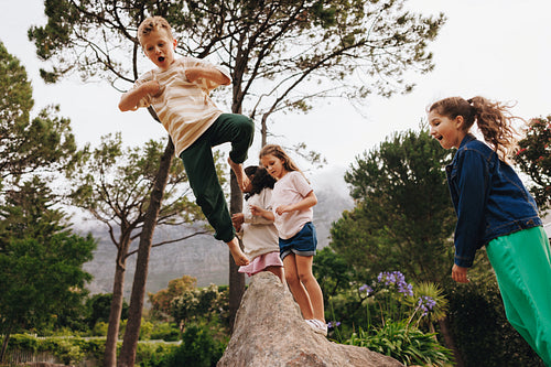 Children playing outdoors with friends on a fun and adventurous day together