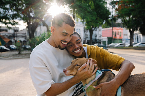 Young couple enjoying time outdoors with their beloved dog