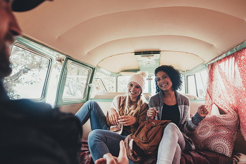 Friends travelling together in a van and having fun.