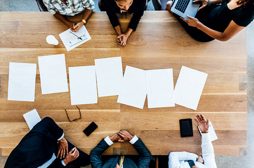 Blank placards on table with business people sitting around