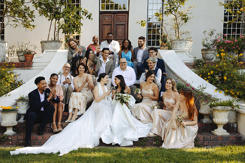 A micro wedding celebration with a joyful and diverse bridal party outdoors