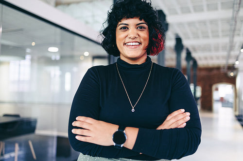 Female entrepreneur smiling in a creative office