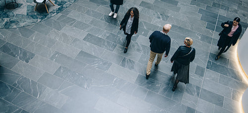 People walking through a office hallway