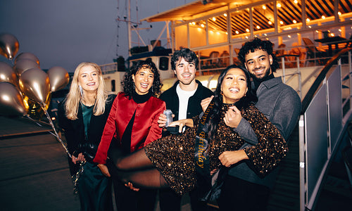 Friends celebrating at a lively party with festive lights and laughter