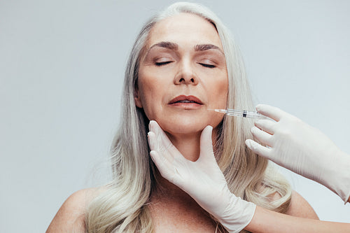 Female getting anti aging shots on her face