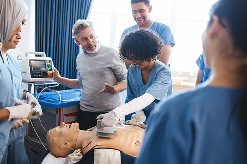 Medical training: Health professional teaches students resuscitation with a defibrillator