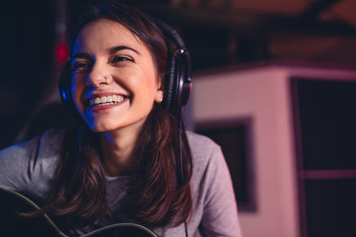 Woman singing a song in recording studio