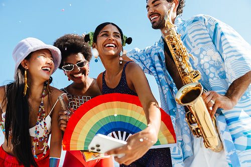 Friends celebrate carnival on sunny beach