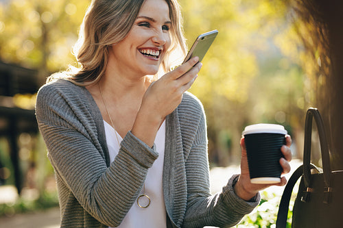 Woman sitting outdoors talking on phone