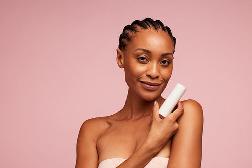 Beautiful woman presenting skincare product