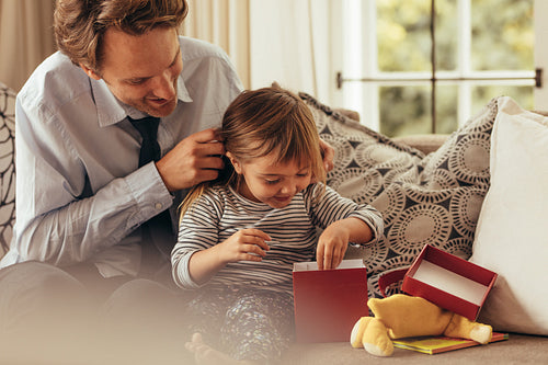 Father and daughter opening a gift box