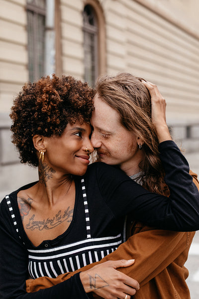 Intimate embrace on a city sidewalk, a moment of affection