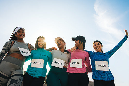 Diverse group of women celebrating after successful marathon