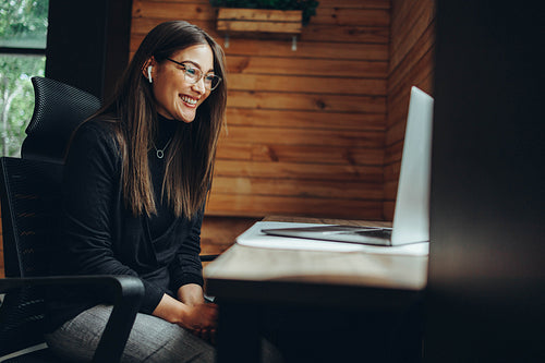Modern businesswoman having a video call in a coworking space