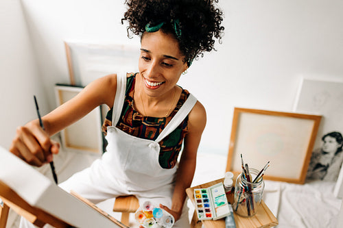 Female painter drawing in her art studio