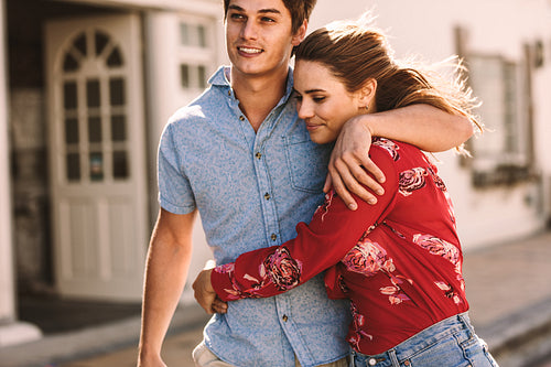 Happy couple walking on street together