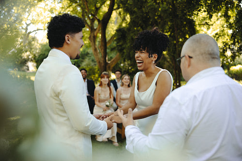 Joyful wedding ceremony of a couple surrounded by friends in a garden