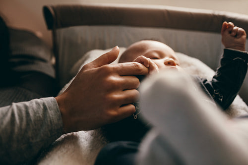 Close up of a baby sleeping on his crib