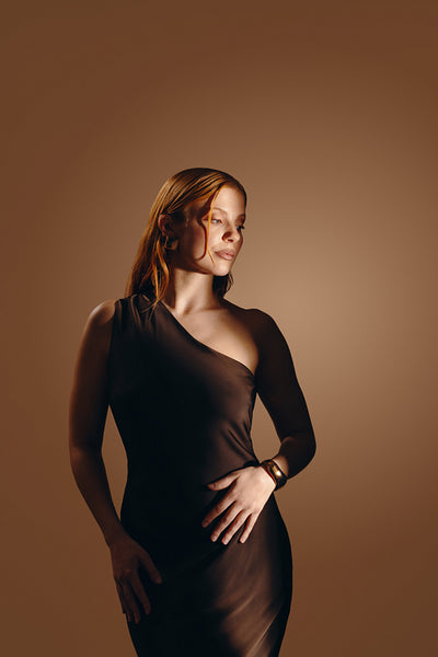 Elegant woman portrait in evening dress with thoughtful gaze