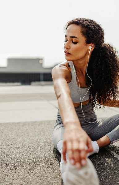 Sportswoman stretching outdoors