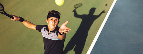 Tennis player about to serve in the game