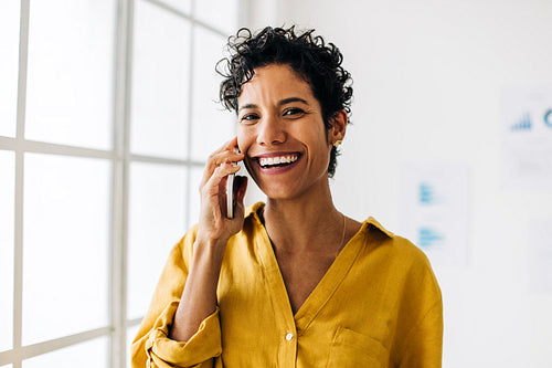 Woman making a call to one of her business contacts in an office