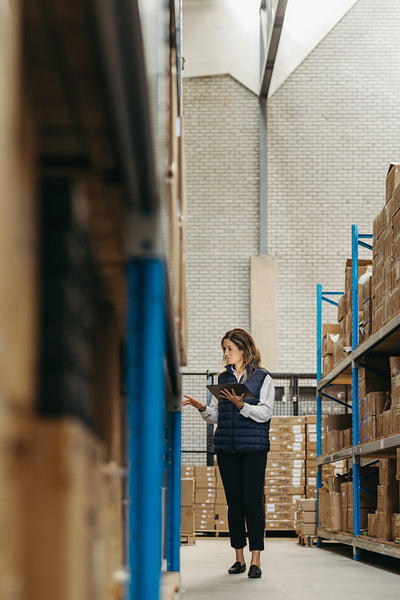 Warehouse worker taking inventory using smart warehousing technology
