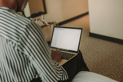 Female executive working from hotel room