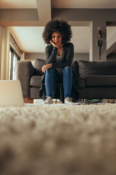 Woman looking at documents on floor