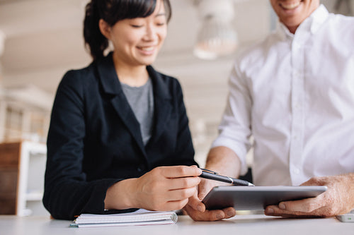 Businesspeople using touchscreen computer in office