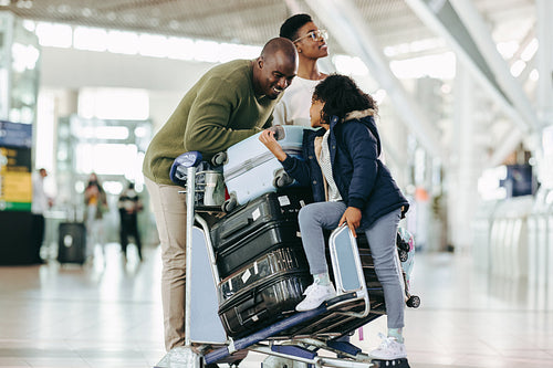 African family with luggage waiting at airport