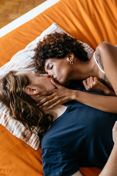 Intimate couple sharing a tender moment on a cozy bed