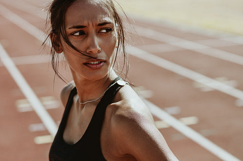 Sportswoman after a run on the stadium track