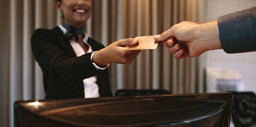 Businessman paying for hotel room at reception