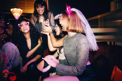 Group of women enjoying a party and laughing with joyful expressions