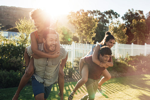 Young people having fun in backyard garden