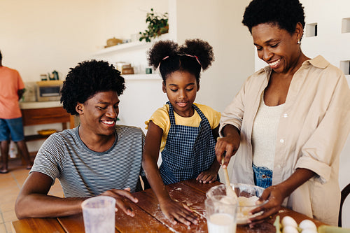 Brazilian mom making a traditional bread recipe with her kids